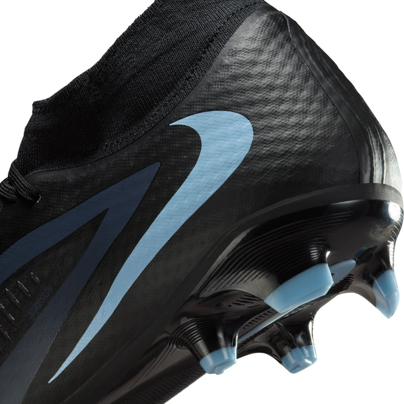 Close-up of black soccer cleat toe and heel with light blue studs detail