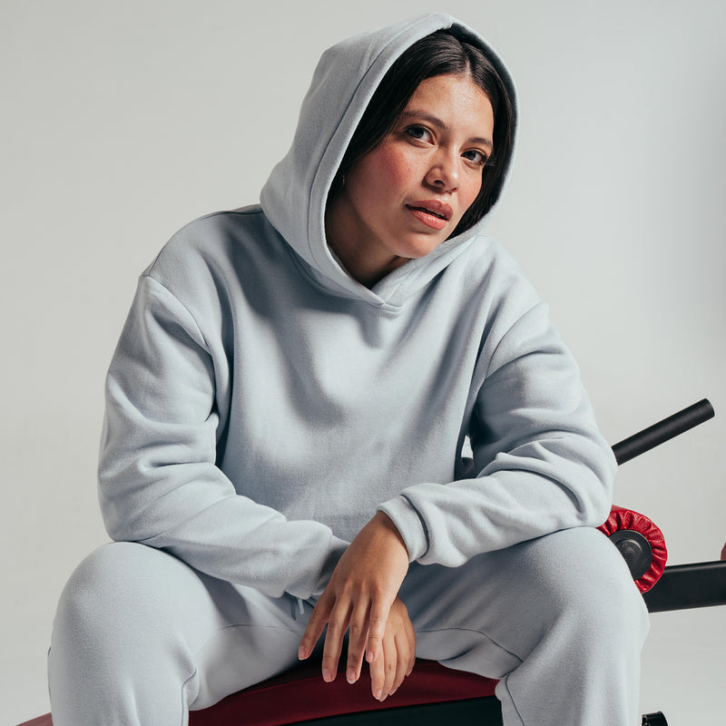 Light blue-gray fleece hoodie with hood and long sleeves, drawcord hood