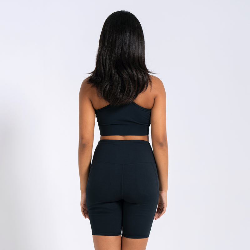 Women's black sports bra back view with crisscross racerback strap detail