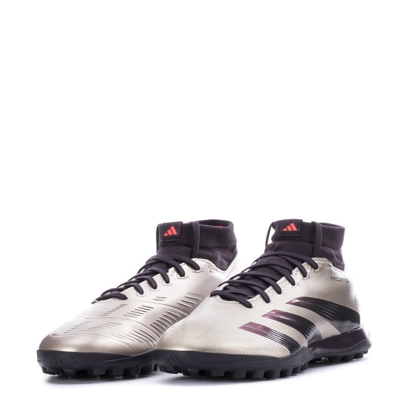 Pair of men's mid-cut TF soccer cleats, metallic silver with black socks and purple accents