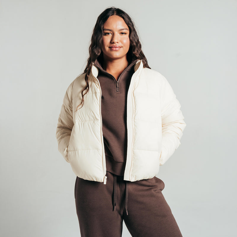 Women's parchment puffer jacket, full-zip front, worn over hoodie
