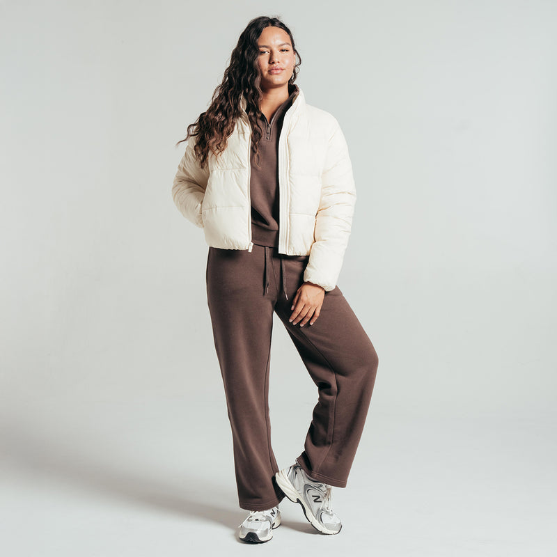 Women's parchment puffer jacket with full-zip front, model standing