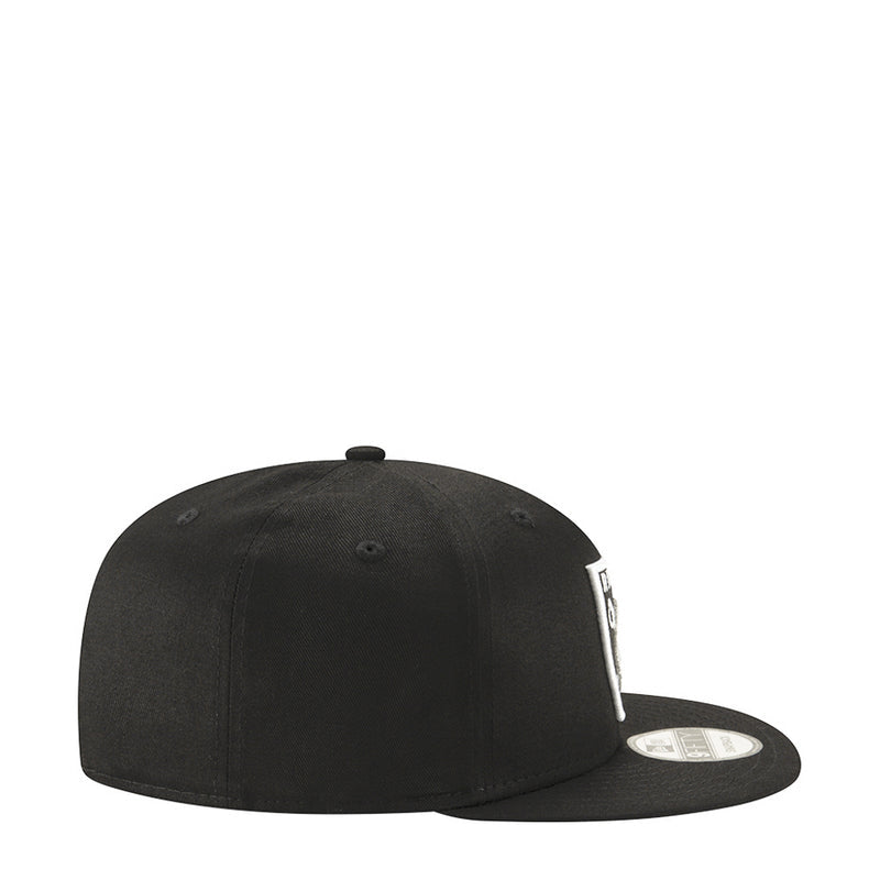 Black Raiders logo cap, side profile view with curved brim and snapback