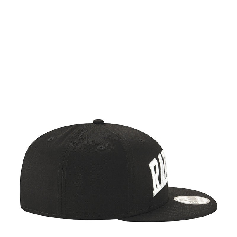Black baseball cap with partial white Raiders lettering on the side