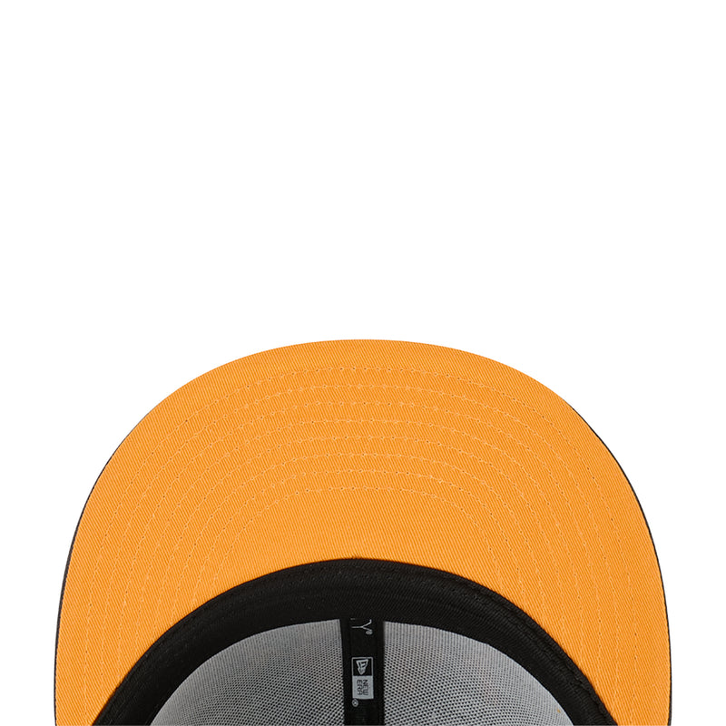 Orange baseball cap close-up of crown and black inner band with interior tag