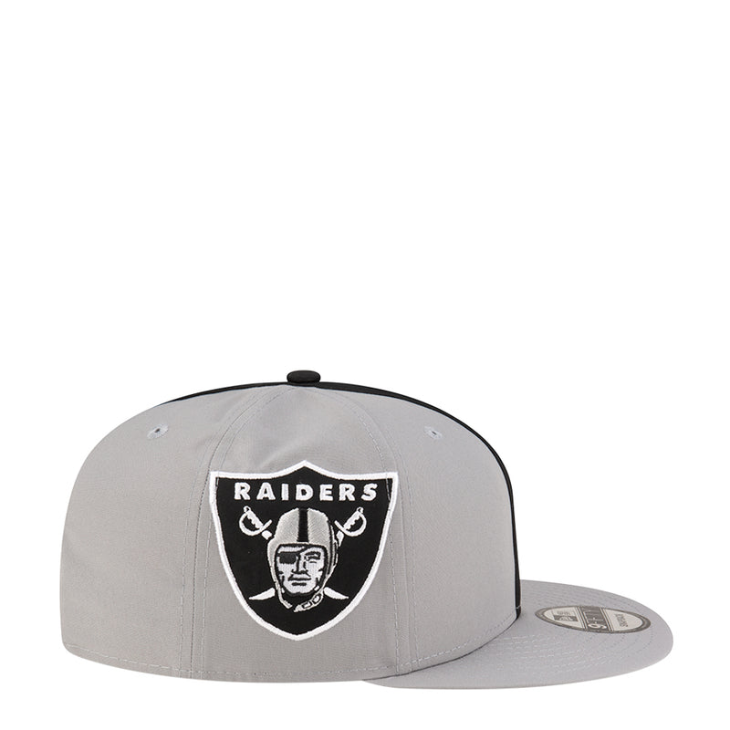 Light grey snapback cap with Raiders shield logo on front