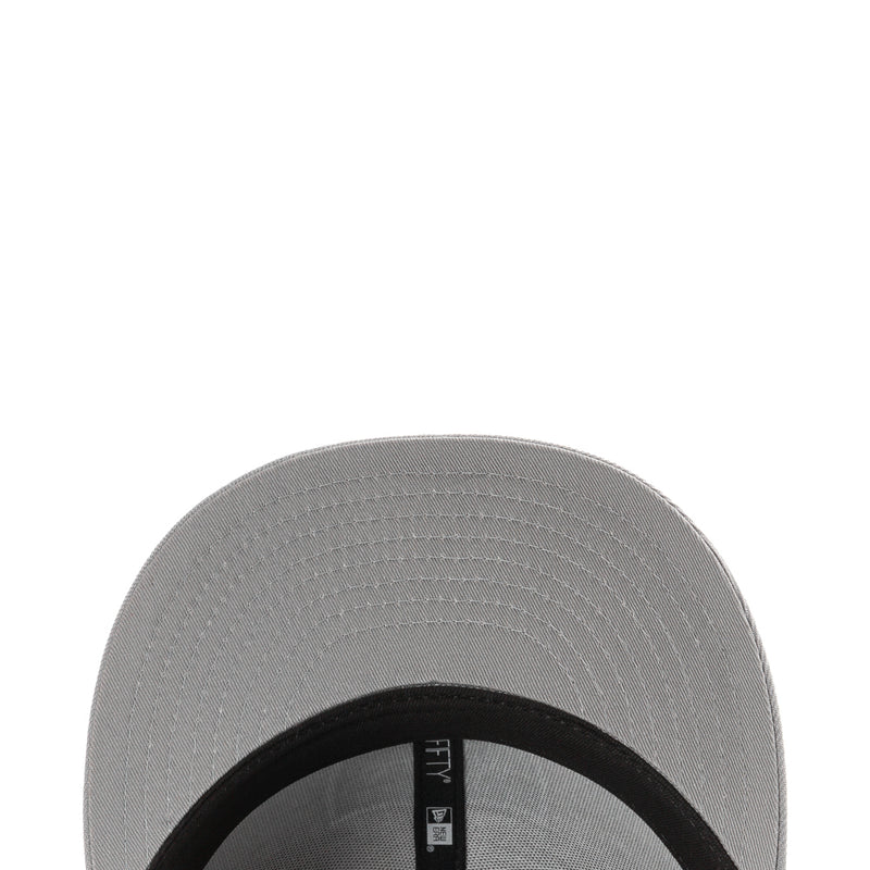 Grey baseball cap close-up of brim with black inner band and New Era label