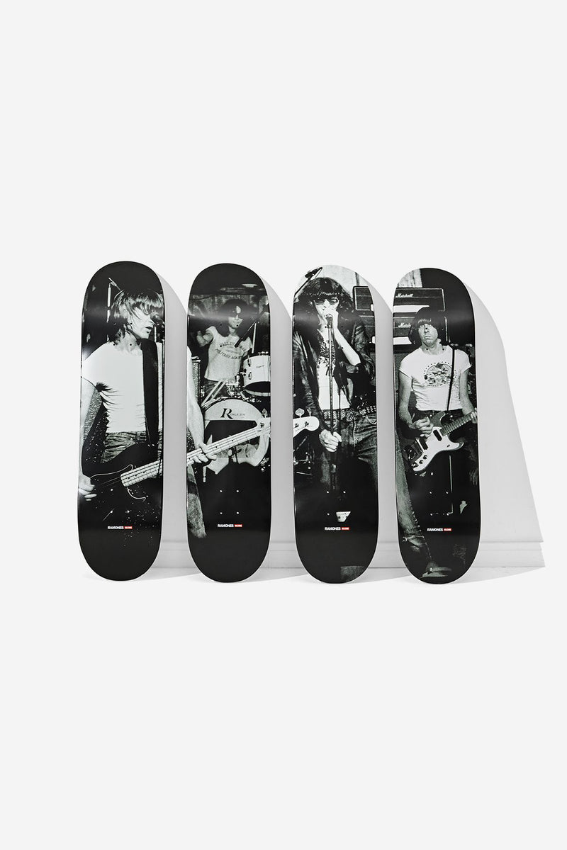 Ramones Collector's Set four 8.25 inch decks upright with grayscale CBGB performance photos against a white wall.
