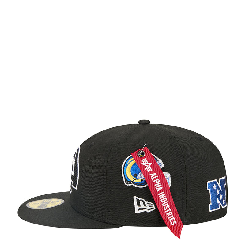 Black baseball cap with colorful Rams crest, “ALPHA INDUSTRIES” ribbon, and NFL logo.