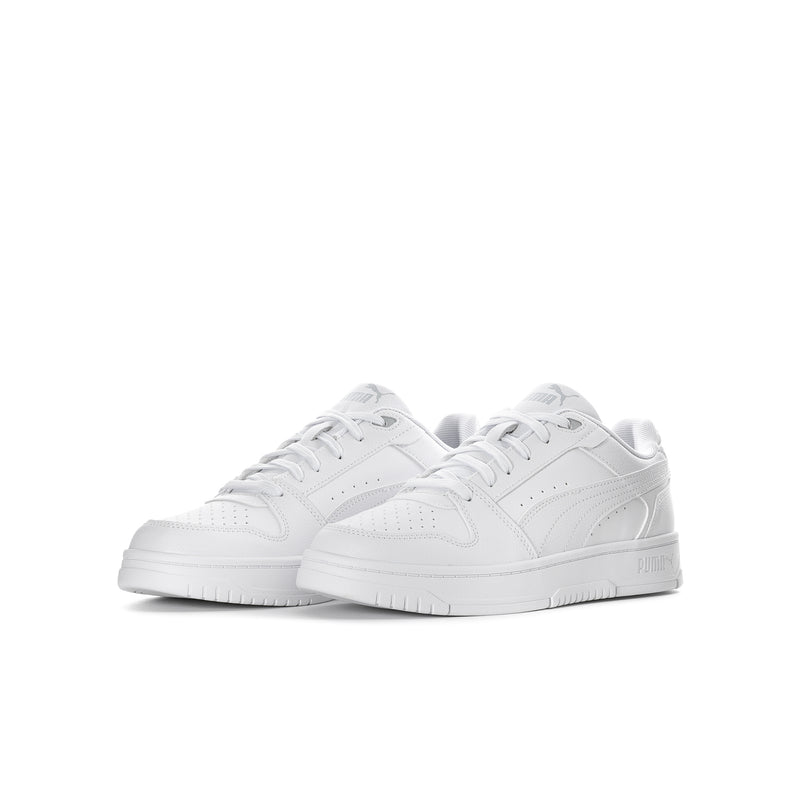 Pair of youth white Puma lace-up sneakers with cushioned sole and side stripe logo