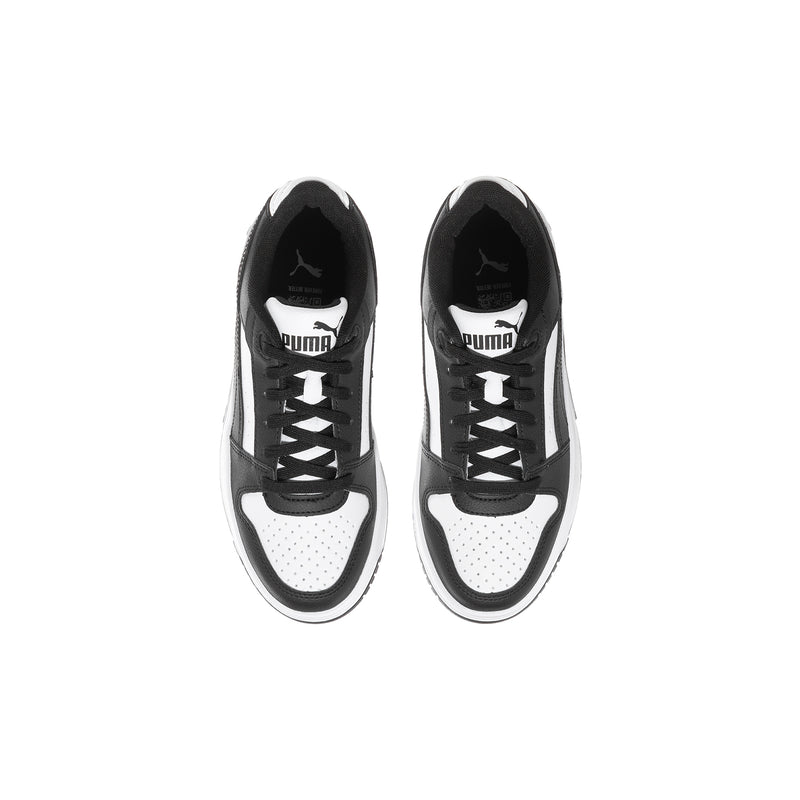 Pair of youth lace-up sneakers, black and white uppers with PUMA branding at tongue
