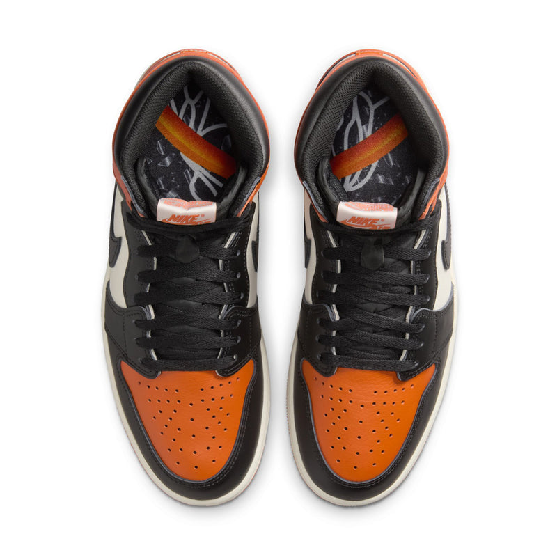 Men's high-top sneakers showing black laces and orange toe perforations, top view.