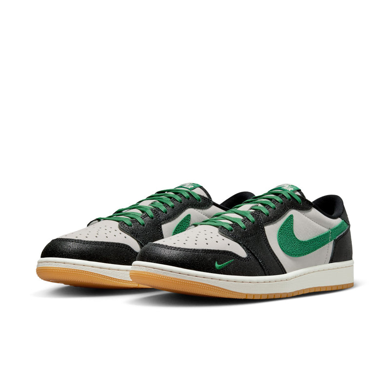 Men's low-top sneakers, black with green accents over white panels, lace-up.