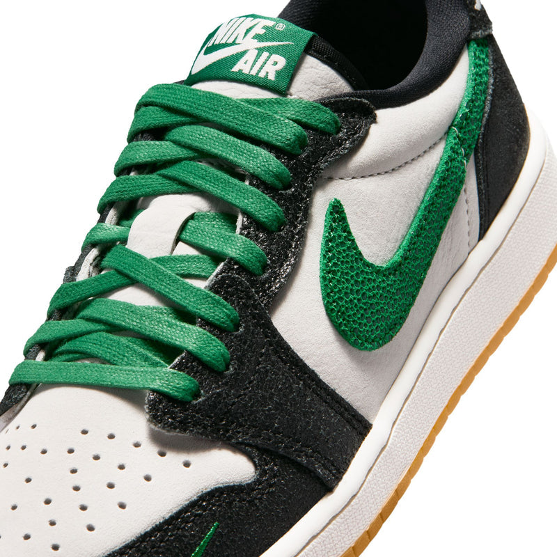 Close-up of youth sneaker laces and swoosh, textured black with green accents