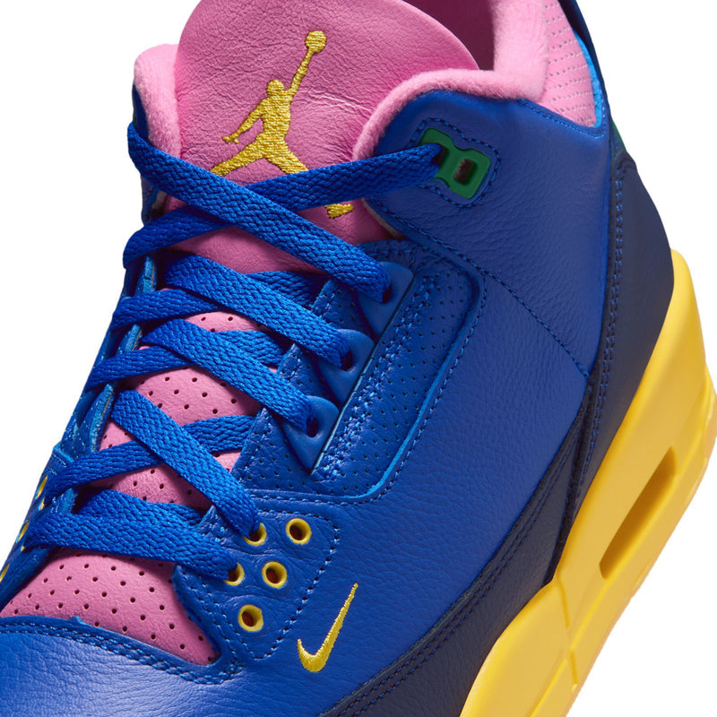 Close-up of men's retro high-top sneakers: blue leather laces, pink inner collar, Air Jordan logo.