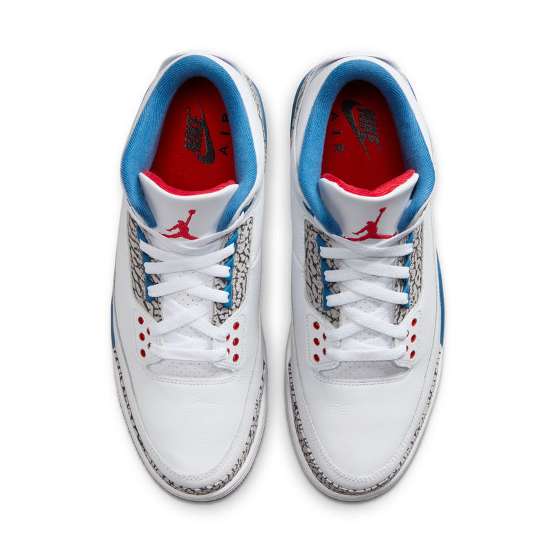 Men's white sneakers front view with blue lining, red Jumpman logo, and elephant print