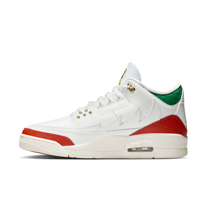 White retro sneakers with red side stripe, green collar lining, and Air heel