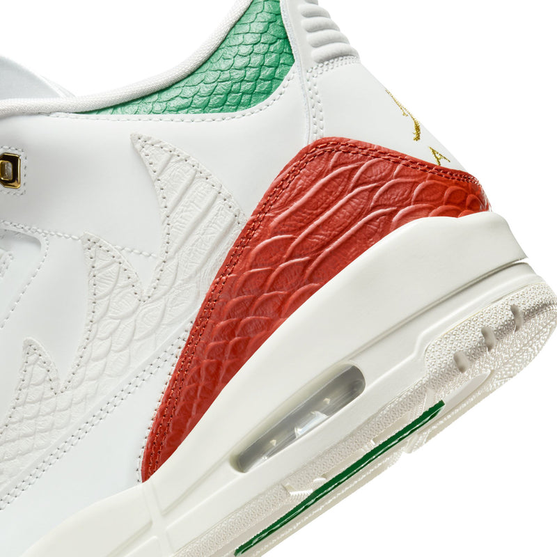 Side close-up of white retro sneakers with red leather panel and green Air unit