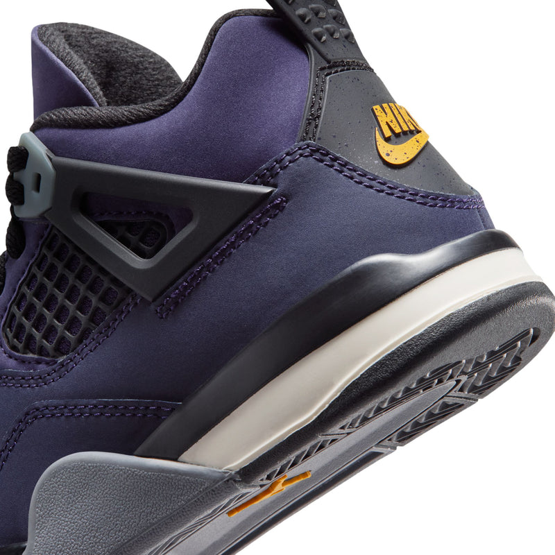 Close-up of kids’ purple sneaker with textured strap, black details, and side swoosh