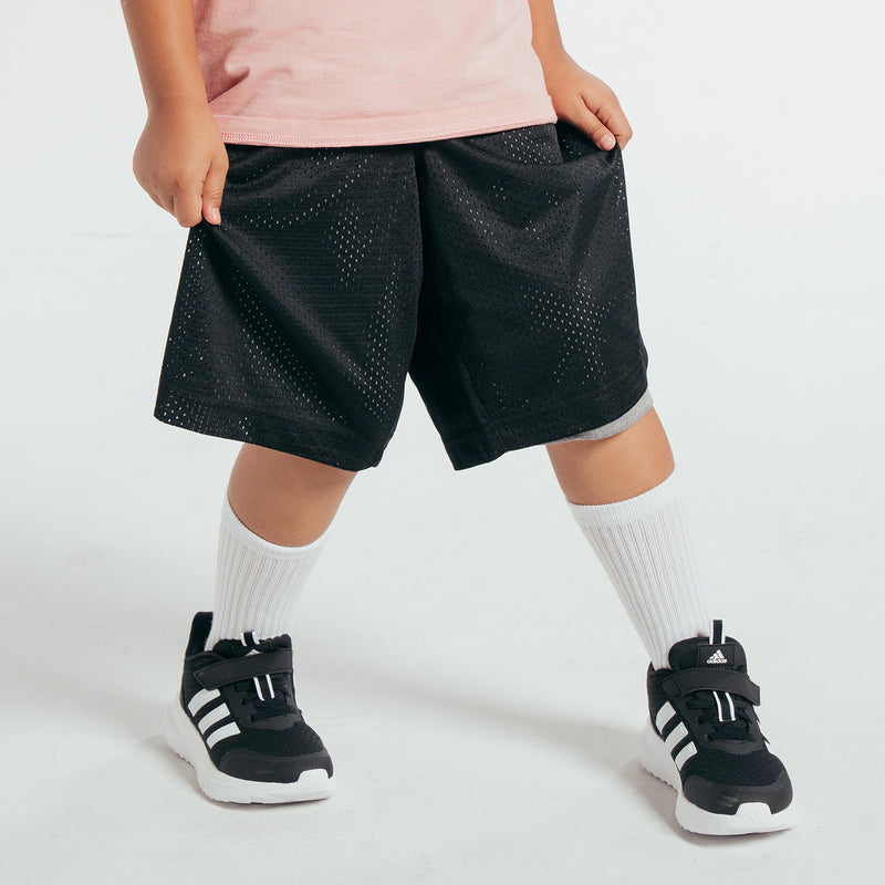 Youth basketball shorts, black perforated outer with mid-thigh length and elastic waistband