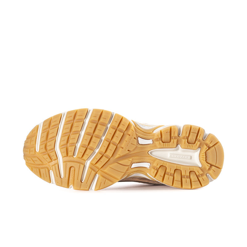 Women’s sneaker outsole view with tan rubber tread and white midsole edge