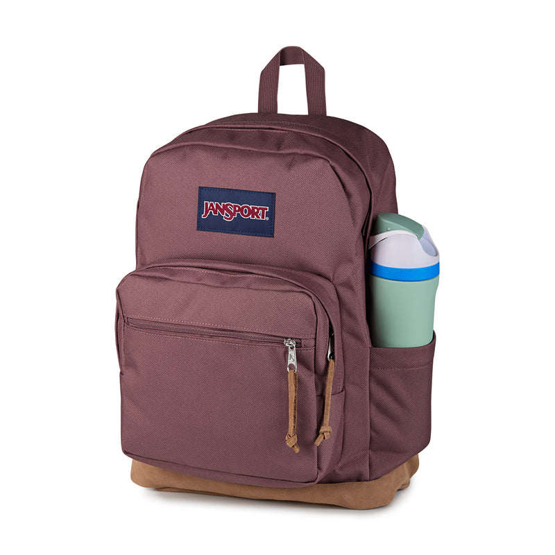 Mahogany Haze JanSport backpack with front zip pocket and side compartment holding a bottle
