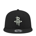 Black snapback cap with NBA Rockets logo on front panel, curved brim