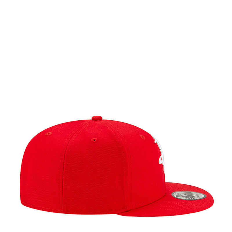 Red baseball cap side view with curved brim and small white logo detail