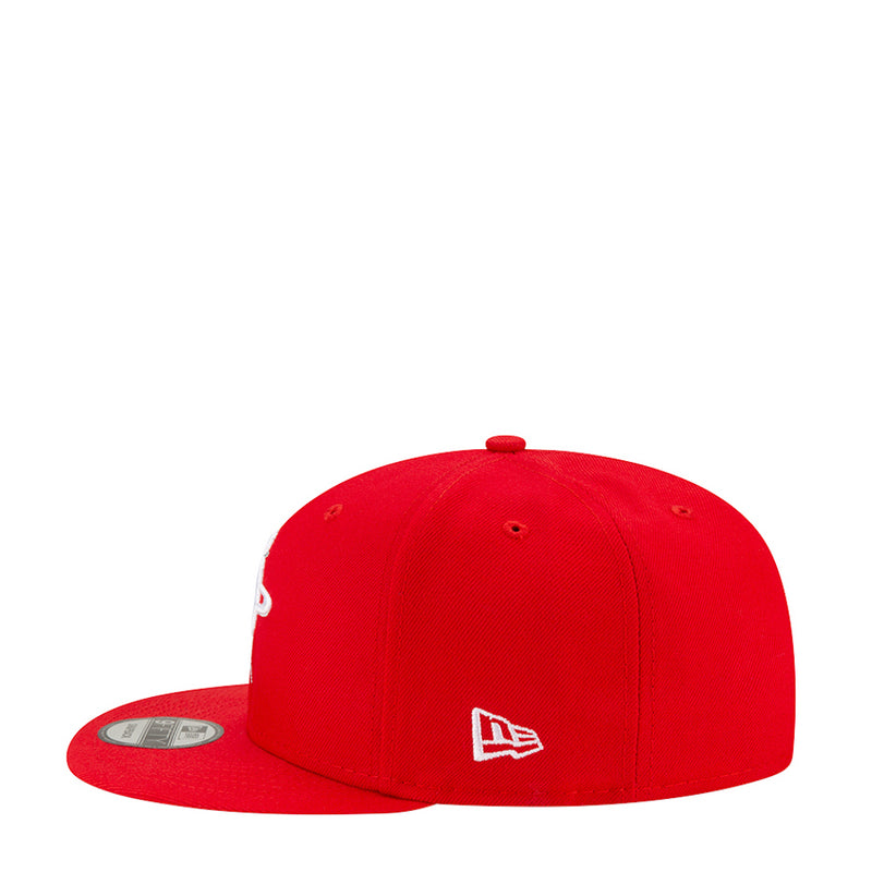 Red baseball cap with white emblem on the side and curved brim