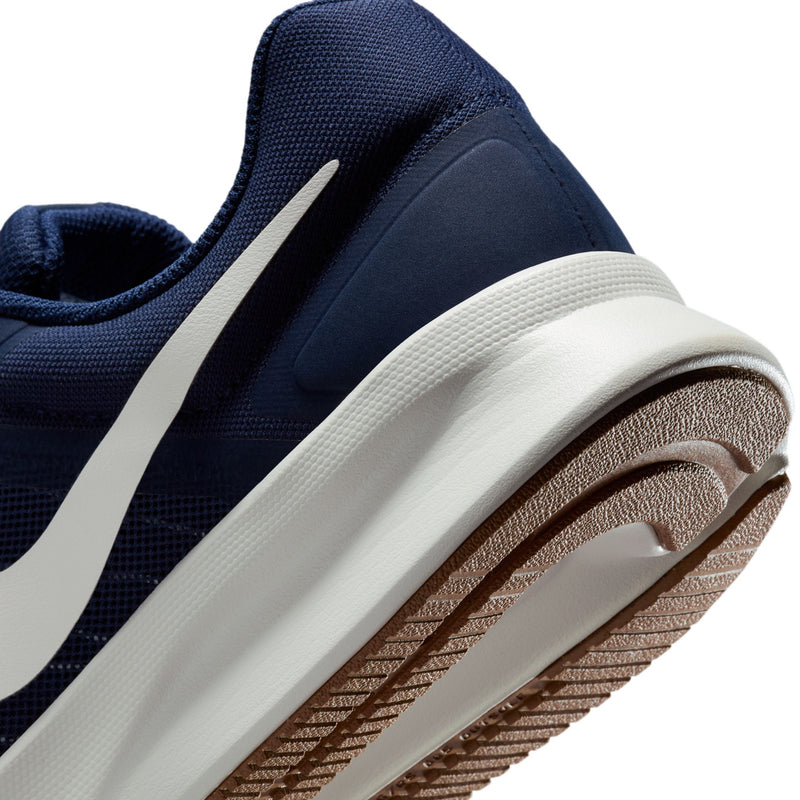 Men's shoe quarter panel close-up with white midsole edge and gum outsole