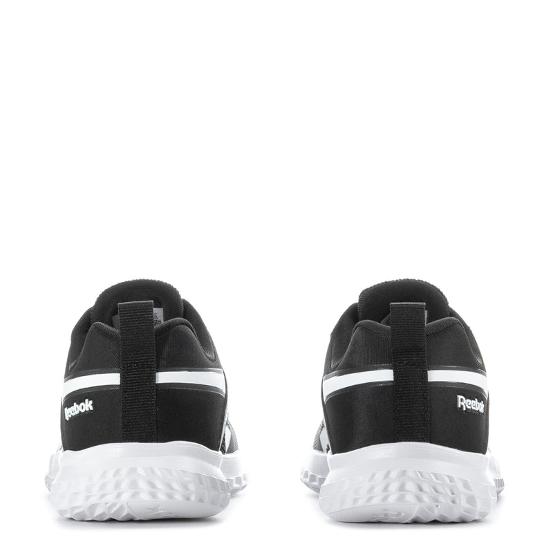 Kids black running sneakers, heel view with Reebok logo and white tread sole