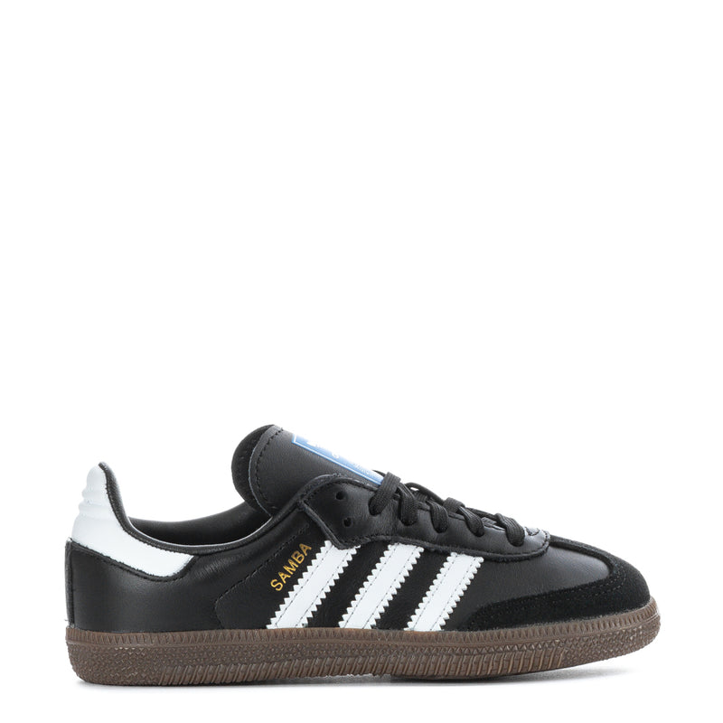 Kids retro sneakers, black with white triple stripes and gum-brown sole.