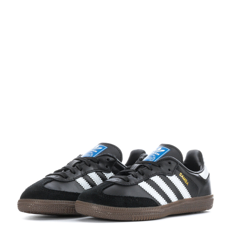 Pair of kids retro sneakers, black with white triple stripes and gum-brown soles.