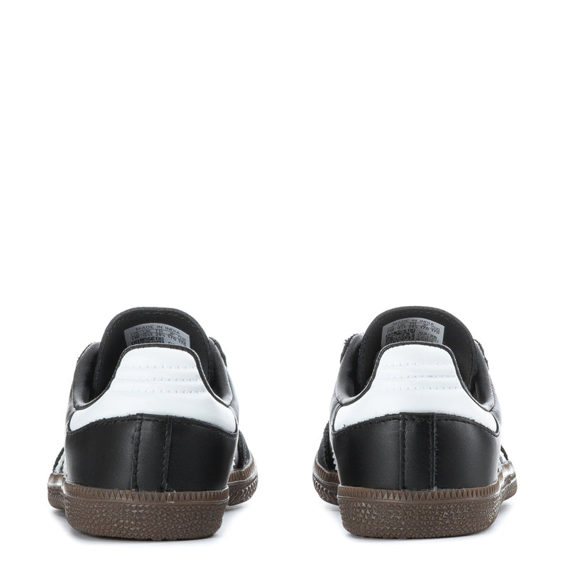 Kids retro sneakers heels, black uppers with white collar and gum-brown soles.