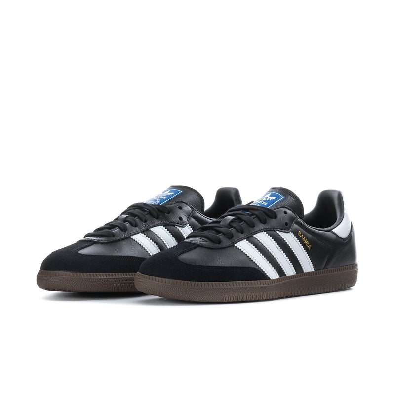 Black adidas Samba OG sneakers with white three-stripe design, black laces, gum sole.