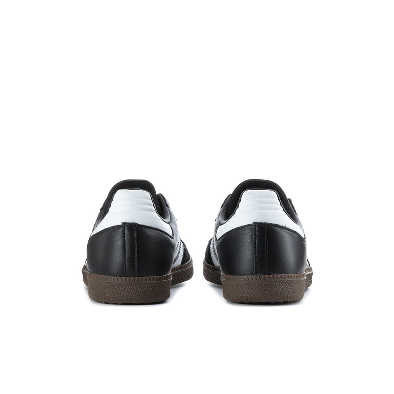 Black adidas Samba OG sneakers with white heel collar detail and gum rubber sole.