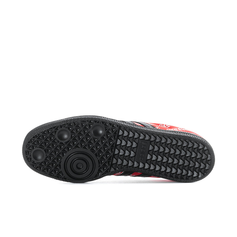 Textured black outsole on red and black Samba OG sneakers with circular logo