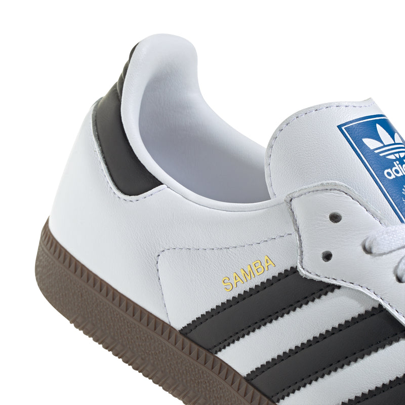 Men's Samba OG sneakers close-up, white leather with black stripes and blue adidas tongue
