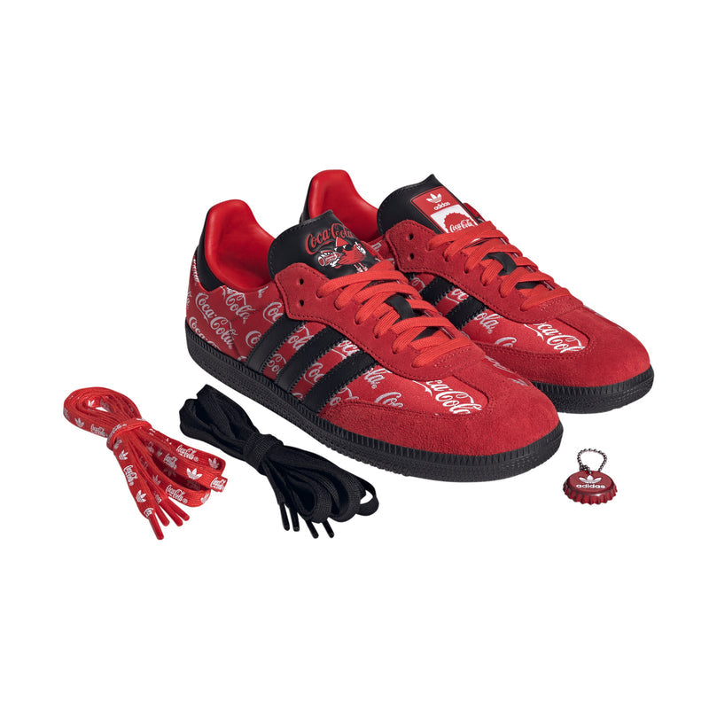Men's red and black sneakers with spare laces and a Coca-Cola keychain charm