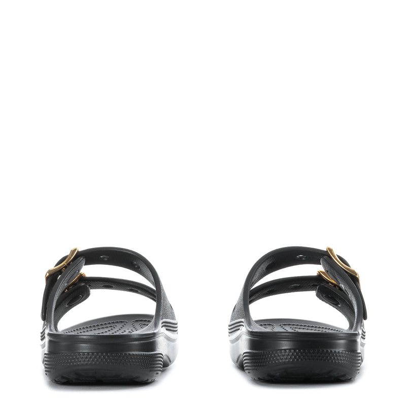 Women's black slide sandal with gold buckle straps at heel