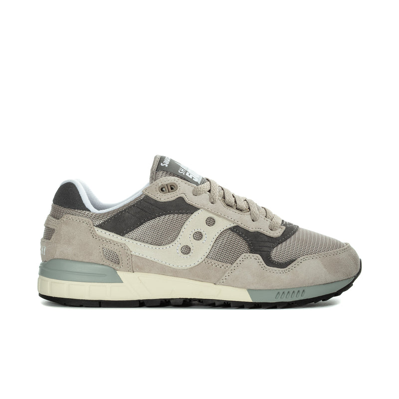 Men's Saucony running sneakers in beige and dark gray, lace-up with teal midsole