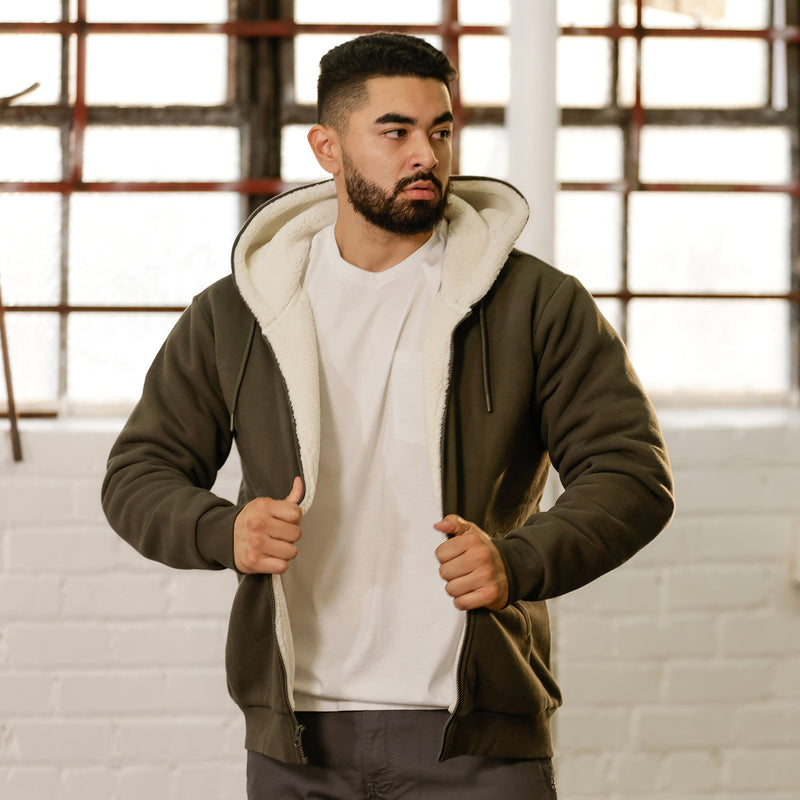 Men's olive sherpa-lined full-zip hoodie with sherpa hood lining, worn by model