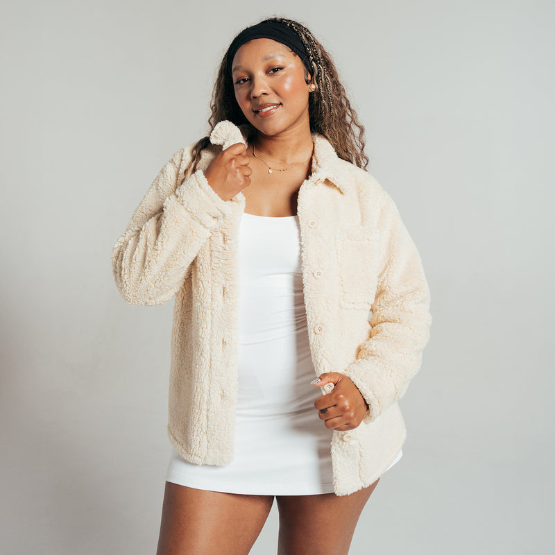 Women’s off-white sherpa shirt jacket with hood, open front, and long sleeves