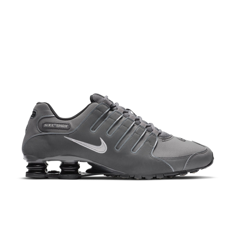 Men's dark gray lace-up sneakers with Nike swoosh and visible Shox cushioning pods