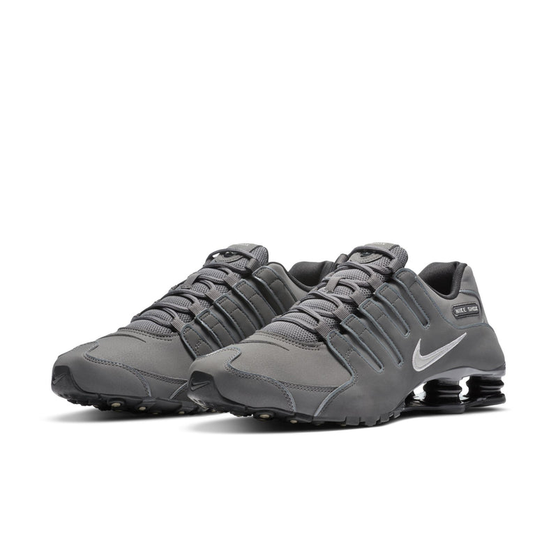 Men's dark gray lace-up sneakers, three-quarter view, with Nike swoosh and Shox pods