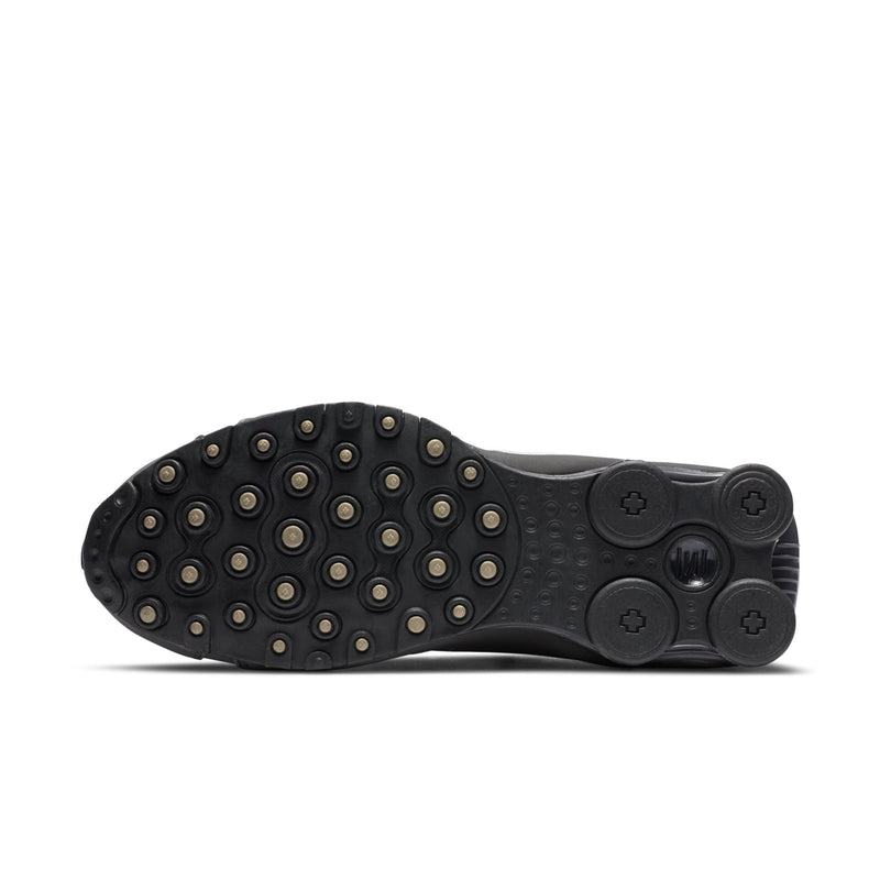 Men's dark gray sneaker outsole with circular traction pods and shock-cushion heel