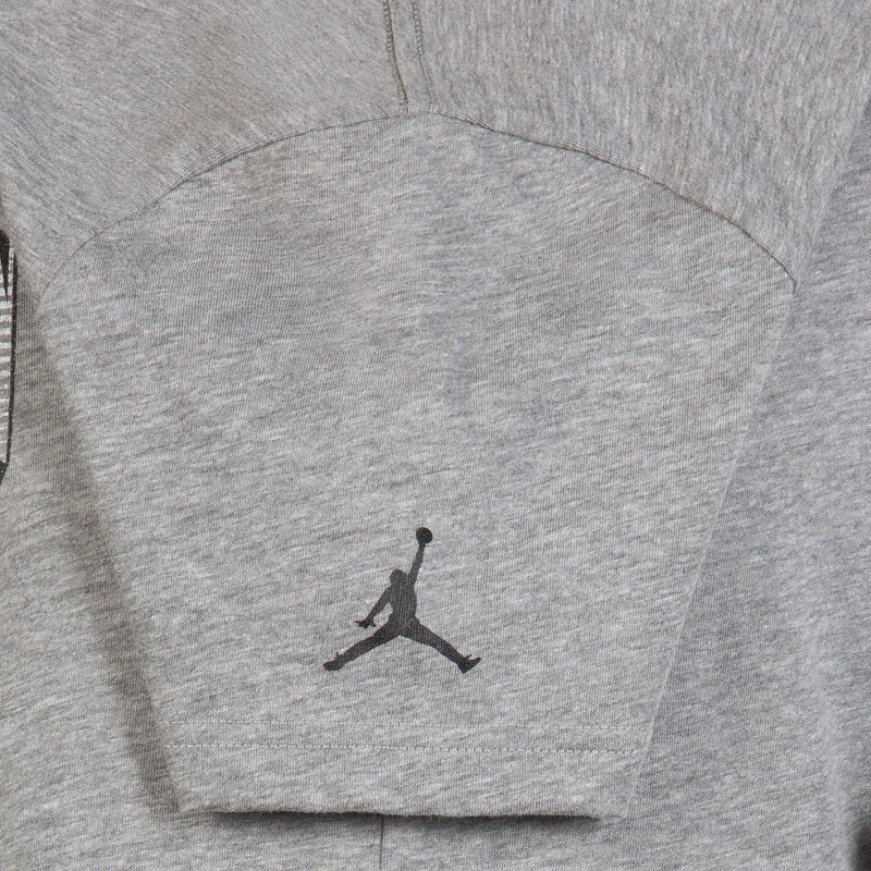 Youth carbon heather T-shirt with small Jumpman logo on back yoke.