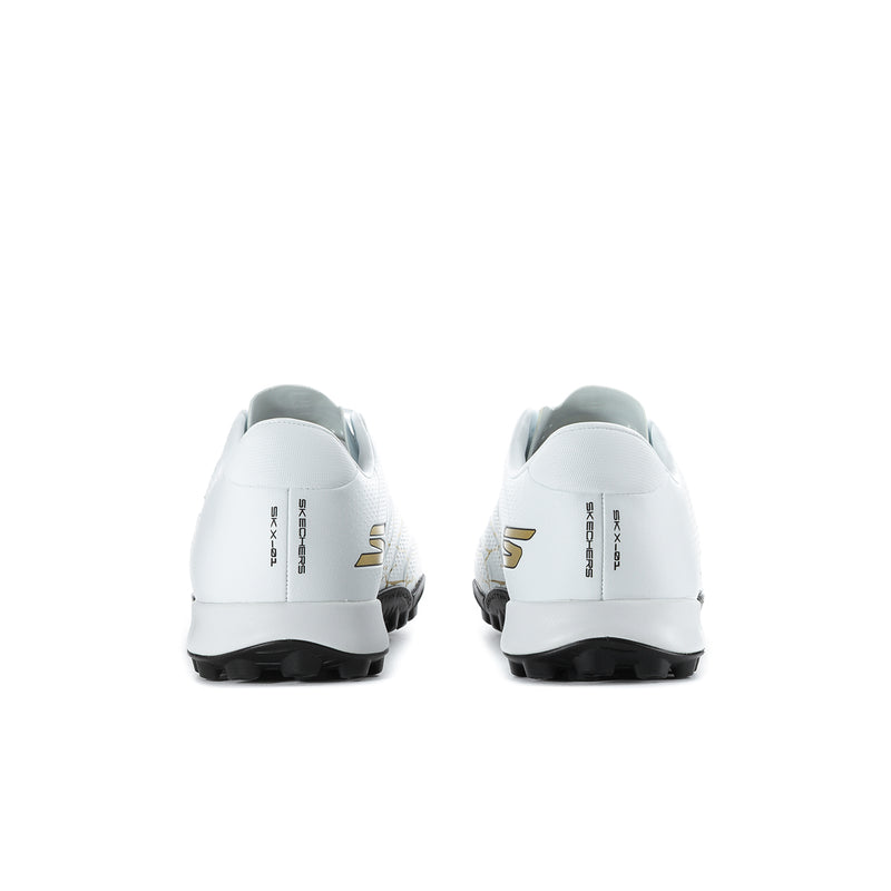 Men’s white soccer cleats, rear view, gold logo accents and molded sole