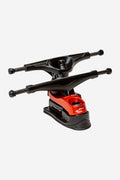 Close-up of Slant Surf Skate Trucks in black and red mounted on a board.
