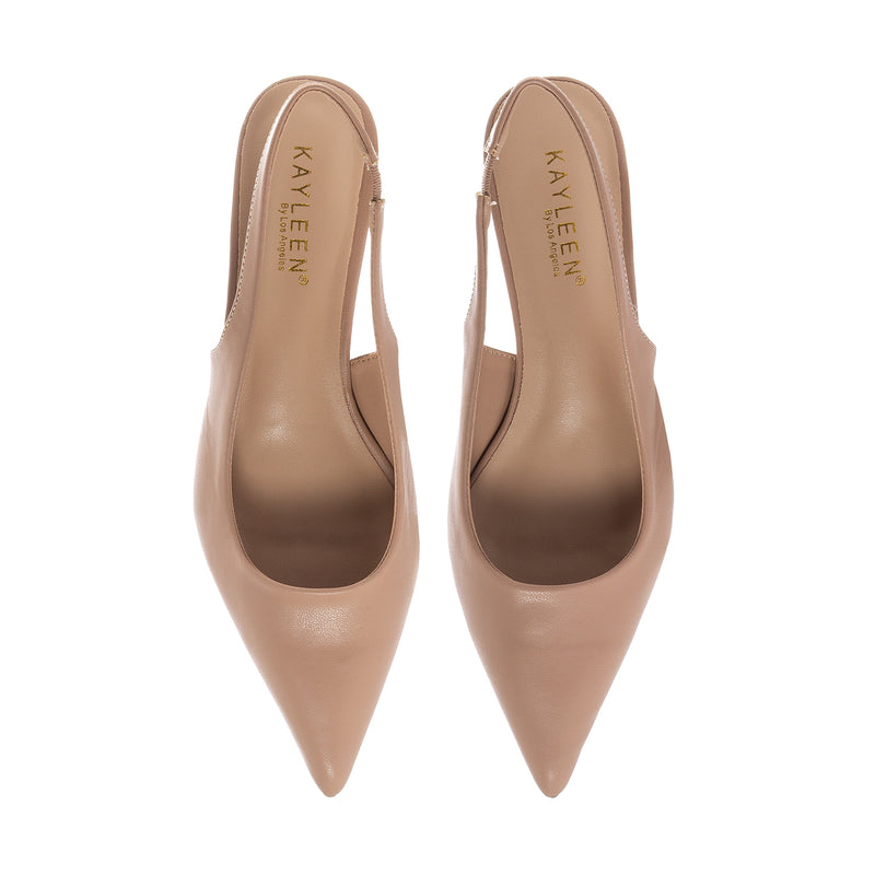 Pair of nude slingback pumps, pointed toe and low heel profile view